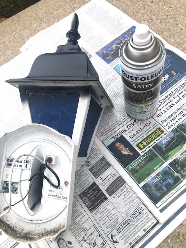 updating an outdated light fixture with spray paint.