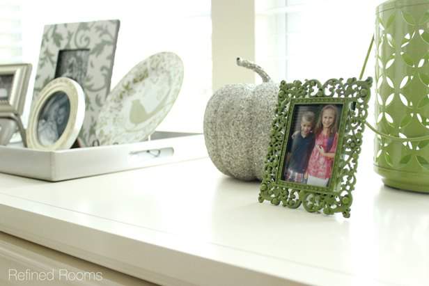 decor accessories on top of a file console in a home office.