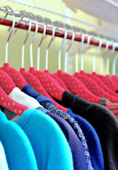 organized kids closet with uniform hangers.