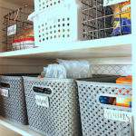 organized kitchen pantry with stackable storage bins.