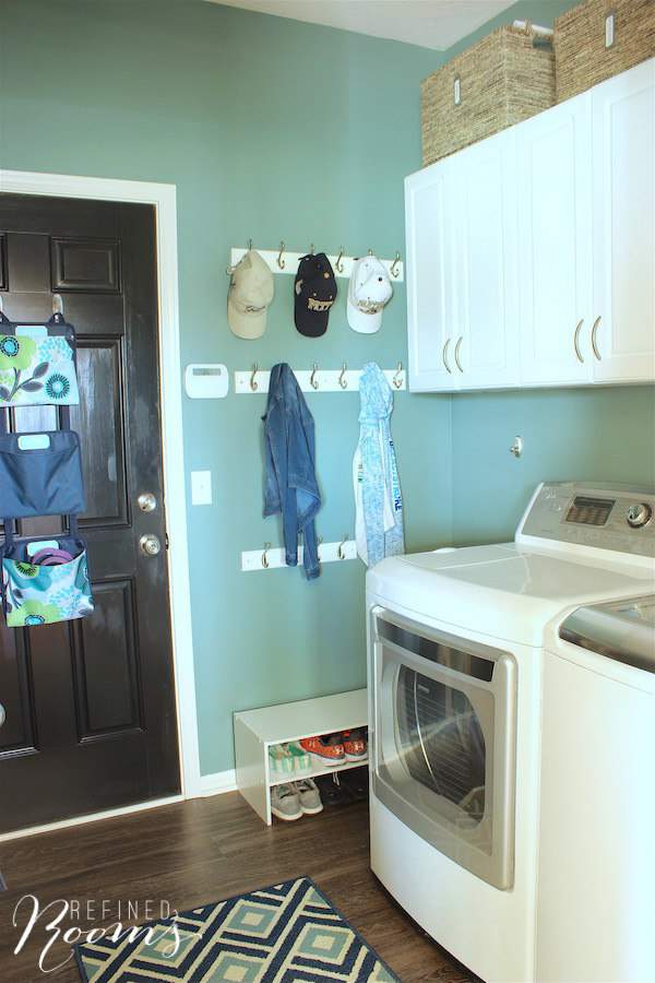 So excited to share my laundry room makeover reveal! Come see how new flooring, lighting, storage and simple wall decor completely transformed this space