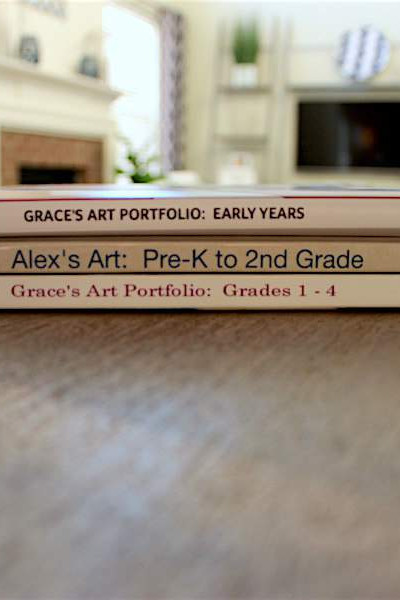 stack of digital photo books to organize kids artwork.