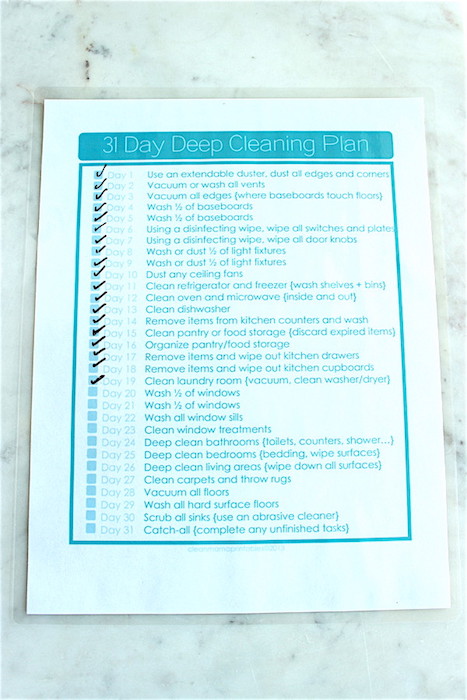 laminated Deep cleaning checklist on countertop.