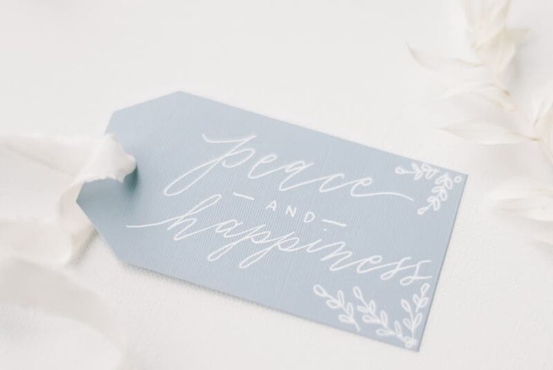 blue gift tag with "peace and happiness" written on it.