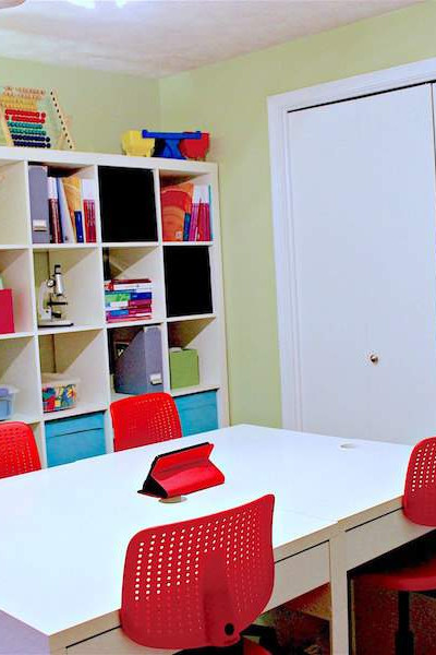 This room was transformed into an awesomely organized home school space using IKEA storage products, including this Kallax shelving. Click to see the transformation!