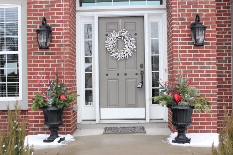 example of staged front entrance of home in winter with decorative urns