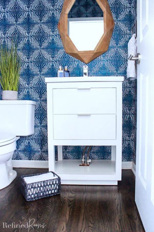 modern white bathroom vanity with hole cut out on bottom for plumbing.