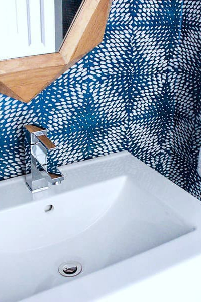 square white porcelain modern sink with soap and patterned hand towel.