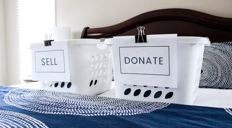 laundry baskets with Sell and Donate labels for decluttering.