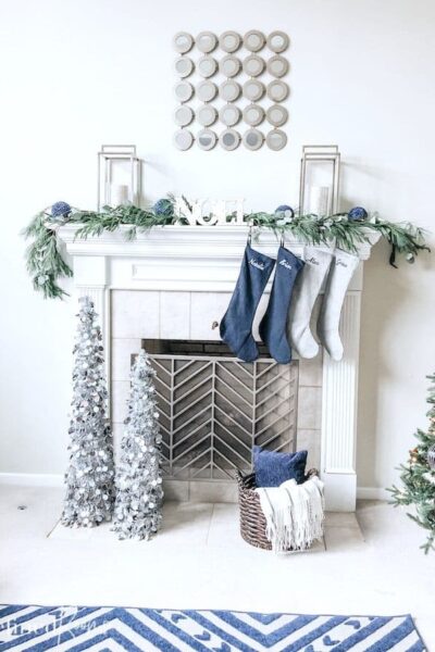 fireplace mantel decorated for Christmas with navy blue decor.